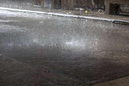 hard raining on the floor with droplet splash with soft lightの写真素材