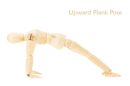 demonstration of wood manikin in upward plank pose on white background. this pose is part of yoga training.の写真素材