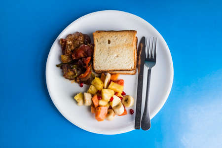 buffet dish on blue table from top view. it mix of india side dish, bread and fruit.の写真素材