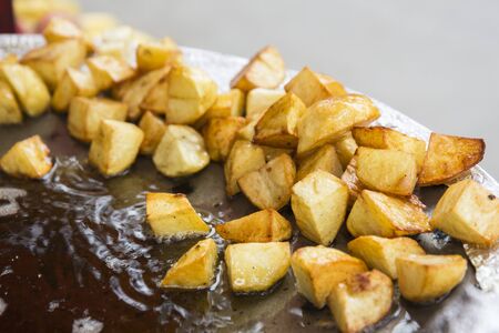 patato dices in frying pan, it is cooking of aloo chaat dish. patato in Hindu name call Aloo.