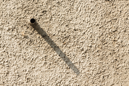 background of pipe shadow on rough wall in morning time
