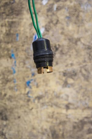hanging of empty base lamp on grunge background
