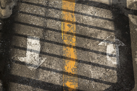 shadow line on two direction arrow sign on grunge floor