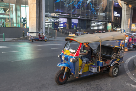 BANGKOK THAILAND - APR 17 : tuktuk is parking on sidewalk of siam square in evening time on april, 17, 2016, thailand. tuktuk is popular taxi service of tourists in bangkokのeditorial素材