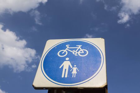 signs of footpath for bike and walk only in blue skyの写真素材