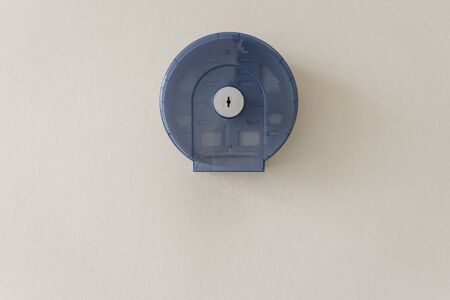 empty clear blue toilet - paper holder on wallの写真素材