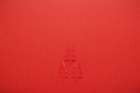 background of group red Christmas tree paper cutting designの写真素材