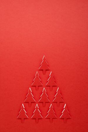 group of red Christmas tree paper cutting design with spaceの写真素材