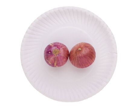 isolated of two shallot on paper dish on white backgroundの写真素材