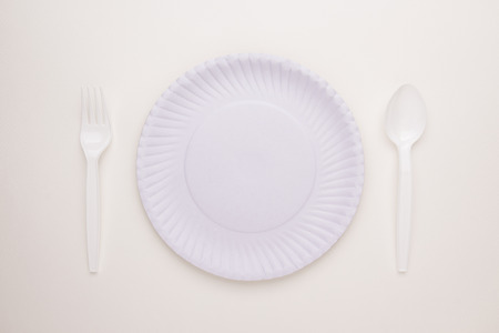 top view of new white dinnerware on white background