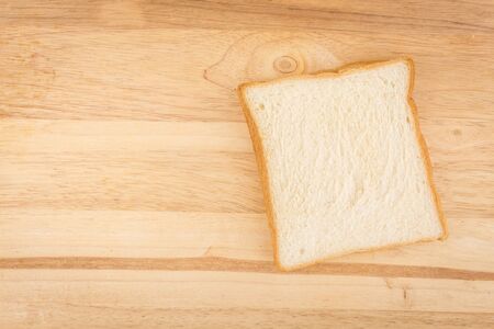 slide of bread put on wooden block backgroundの写真素材