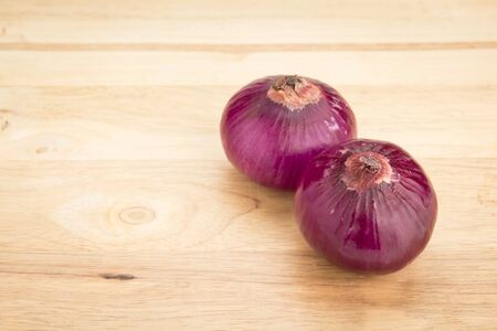 big shallot or curry leave on wooden blockの写真素材