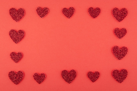 background of glitter red heart array frame on red paper