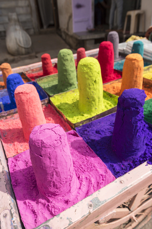 colored colorful powder kumkum on cart stall in Pushkar for holi festival celebration, Indiaの写真素材