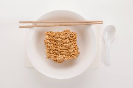top view of raw instant noodle bowl set on white backgroundの写真素材
