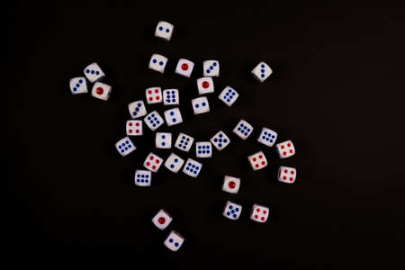 many dice fall on black paper background, concept for business risk, chance, good luck or gamblingの写真素材