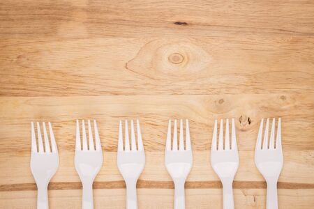 wooden background of white plastic fork array decorationの写真素材