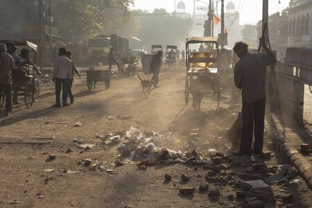 DELHI INDIA-MAR 24 :  worker clean dirty street in morning by sweep in chandni chowk, old delhi of delhi on march, 24, 2015, indiaのeditorial素材