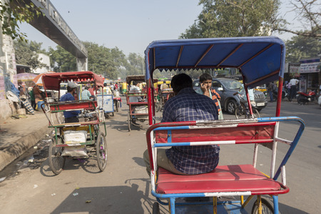DELHI INDIA - NOV 2 : rickshaw driver waiting for passengers near new delhi railway station. this three wheeler bike is taxi in delhi on november, 2, 2014, indiaのeditorial素材