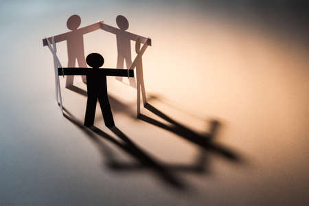 black figure in closed joining of five paper figure on light background. in concept of business,...