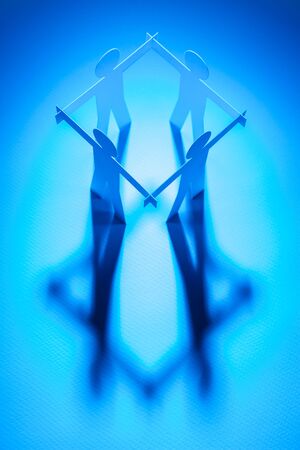 top view of closed joining of four paper figure on blue light background. in concept of business, cooperation and successful.の写真素材