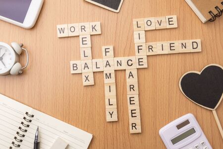 harmony and balance conception of life, work and family by letters wooden block crossword on desk background.の写真素材
