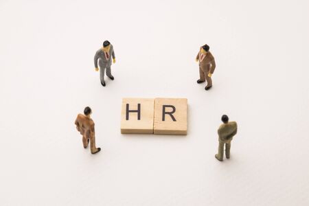 Miniature figures businessman : meeting on hr letters by wooden block word on white paper background, in concept of business and corporationの写真素材