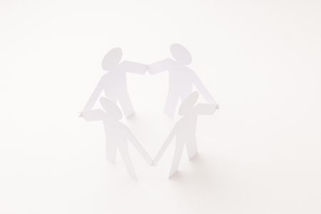 closed joining of four  paper figure in hand down posture on bright white background. in concept of business, cooperation and teamworkの写真素材