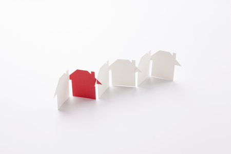 row linked of paper cutout houses with red one on white background, for home and banking conceptual, selective focused.の写真素材