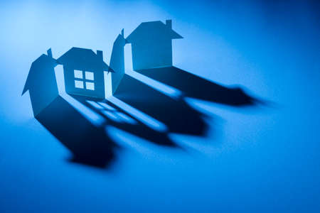 complete one in link of four paper house in blue light with shadow in concept of business and tech.