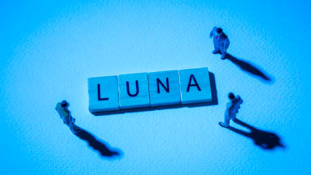 Miniature figures businessman : meeting on LUNA word by wooden block words on white paper background in blue light, LUNA or Terra in concept of digital money, cryptocurrency and business.の写真素材