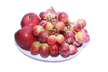 shoot of a bunch of apples and grapes isolated on a white backgroundの写真素材