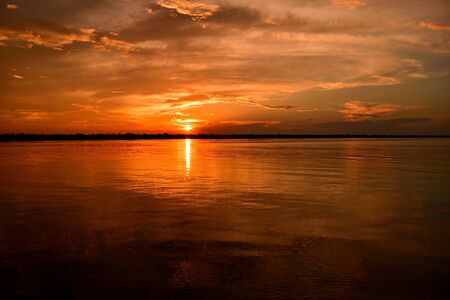 Rio Negro waters and the jungle at sunset, Amazon, Brazil.の写真素材