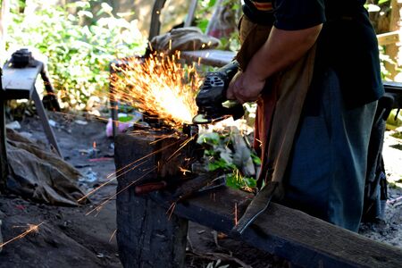 Closeup of a rudimentary iron working process, Cambodiaの写真素材