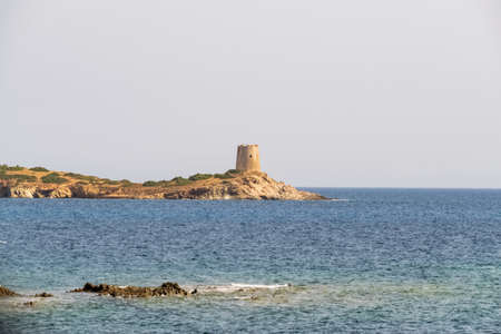 Beautiful view of the southern Sardinian sea. Note the historic Saracen tower on the rock formations.の写真素材