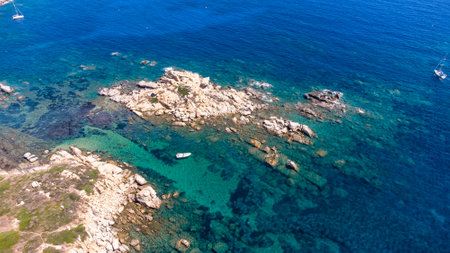 An amazing aerial view of the Sardinian coast. The wonderful colors of the sea contrast with the colors of the rocks.の写真素材