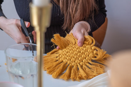 Woman's hands weave macrame decor. handicraft advertisement. copyspace. high quality photoの写真素材