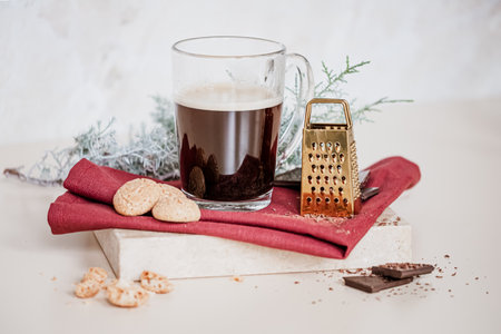 Still life with a cup of coffee latte, cookies and cade branch in Christmas mood. Small gold grater for chocolate. Copy Space. High quality photoの写真素材