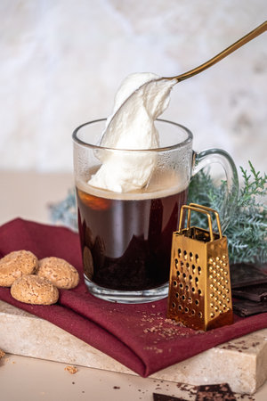 Still life with a cup of coffee latte, cookies and cade branch in Christmas mood. Small gold grater for chocolate. Copy Space. High quality photoの写真素材