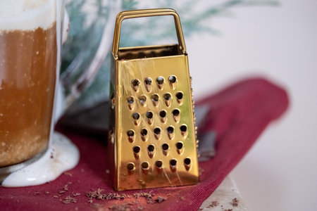 Still life with a cup of coffee latte, cookies and cade branch in Christmas mood. Small gold grater for chocolate. Copy Space. High quality photoの写真素材