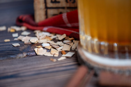Lumberjack set with checkered blanket, metal mug, whiskey glass, wooden coaster and saw blades. Copy space. High quality photoの写真素材