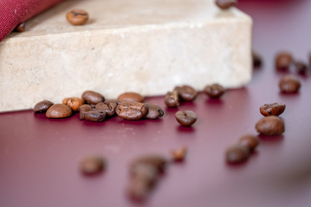 Coffee beans on red table and marble stone pad in background. Copy space. High quality photoの写真素材