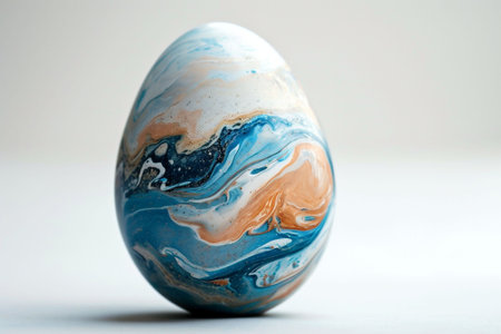 A single colorful marble Easter egg with swirl of blue, orange and white hues rests on a wooden surface, imbued with a natural and artistic essence, perfect for modern Easter decor. High quality photoの素材