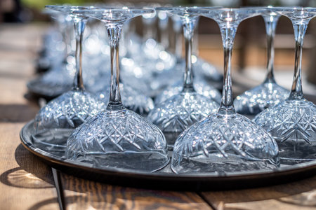 Crystal champagne glasses elegantly arranged on a decorative tray, highlighting their intricate designs and reflections, ideal for a wedding celebration or festive gatheringの写真素材