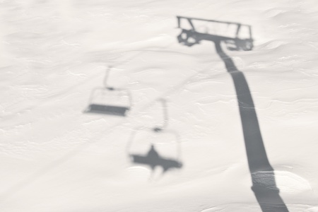 The Shadow of the Chairlift on the snowの写真素材