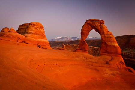 Delicate Arch  A classic, Delicate Arch during the sunset glow, with La Salle Mountins in the...
