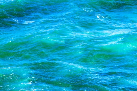 Beautiful blue and turquoise ocean waves in daylightの写真素材