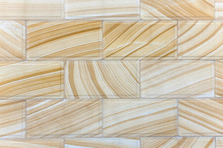 Wall of Sydney Sandstone with its distinctive orange, yellow and cream lines and patterns