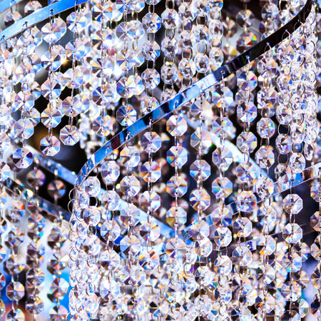 Rows of hanging hexagonal crystals lit up by sunlightの写真素材