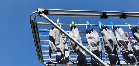 Bonn Germany August 2020 many face masks hang on a clotheshorse to dry in beautiful weather with...